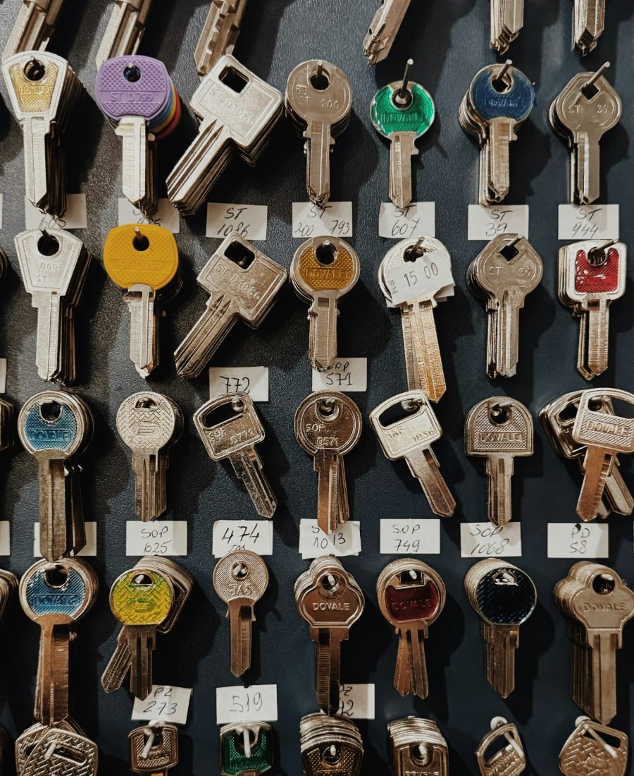 Tall board of key blanks arranged in labelled rows, with coloured and plain metal heads