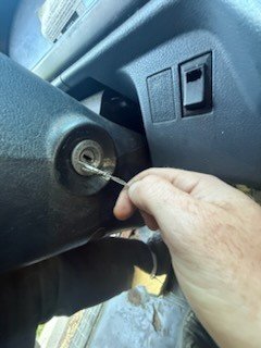 Locksmith working on the ignition cylinder of a car