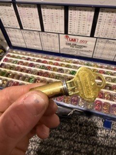 Freshly rekeyed brass cylinder with its new key