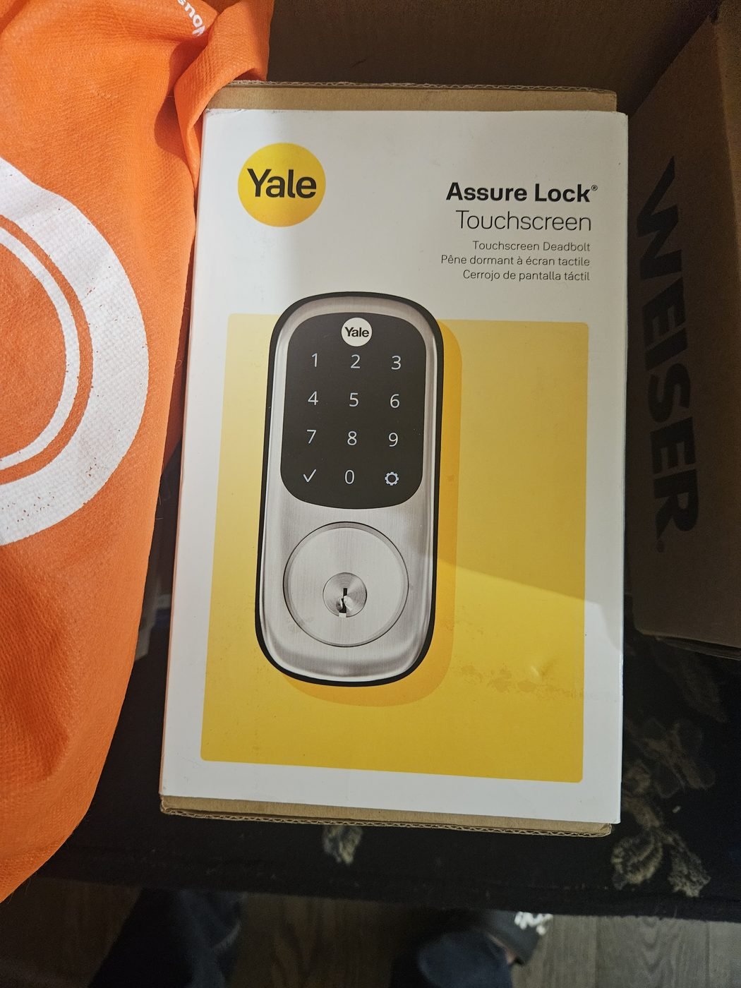 Yale Assure Lock touchscreen deadbolt in its box before installation